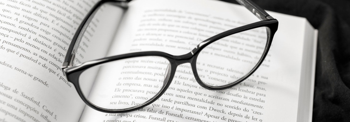 trademark text book with eyeglasses on top
