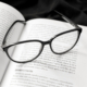 trademark text book with eyeglasses on top